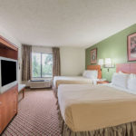 guest room with two beds, TV, nighstand, and window view at Super 8 by Wyndham Fort Worth South