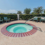 hot tub with chairs and gate around at Super 8 by Wyndham Fort Worth South