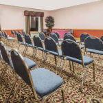 meeting room with rows of chairs lined up at Super 8 by Wyndham Fort Worth South
